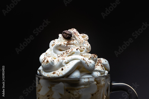 close up of coffee with cream on top in translucid cup photo