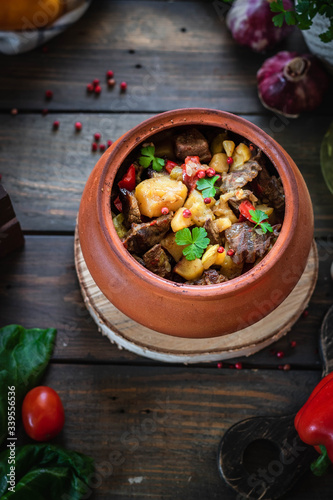 Roast in a clay pot. Braised beef with vegetables. A dish of Georgian cuisine. Chanahi photo