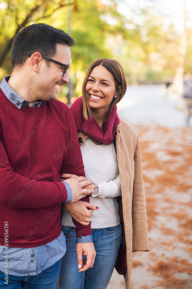 Portrait of a couple walking in the park and holding hands. Portrait of a couple walking in the park and holding hands.