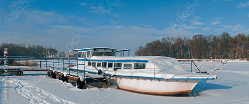 Wallpaper Mural Old boat on the pier in winter. Frozen river, snowy surface. Torontodigital.ca