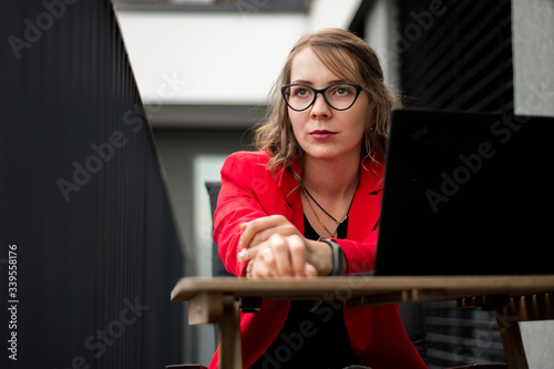 Young business woman working from home on her balcony