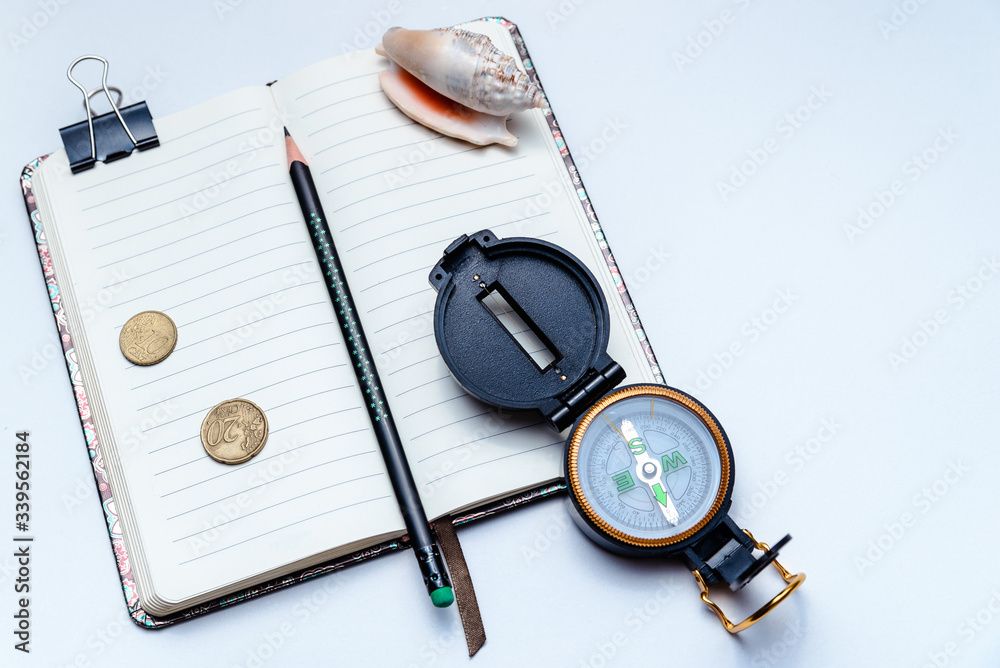 Open notebook, pencil and compass on a white background