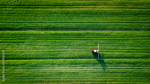 Straight lines field with a tractor spreading 
