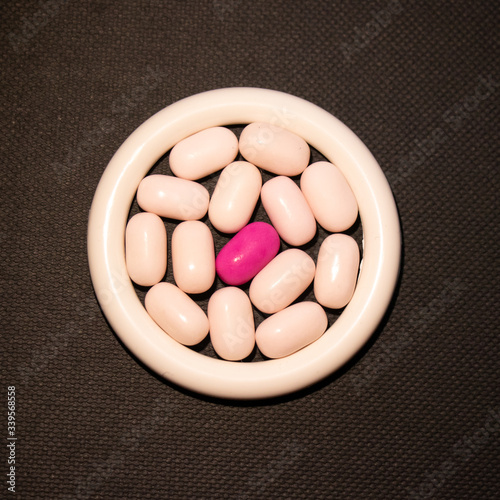 Pharmaceutical medicine tablets on a black background.
