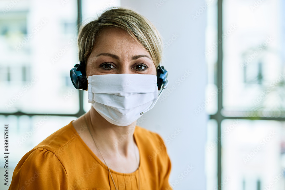 Customer service operator with face mask in the office. Customer service operator with face mask in the office.