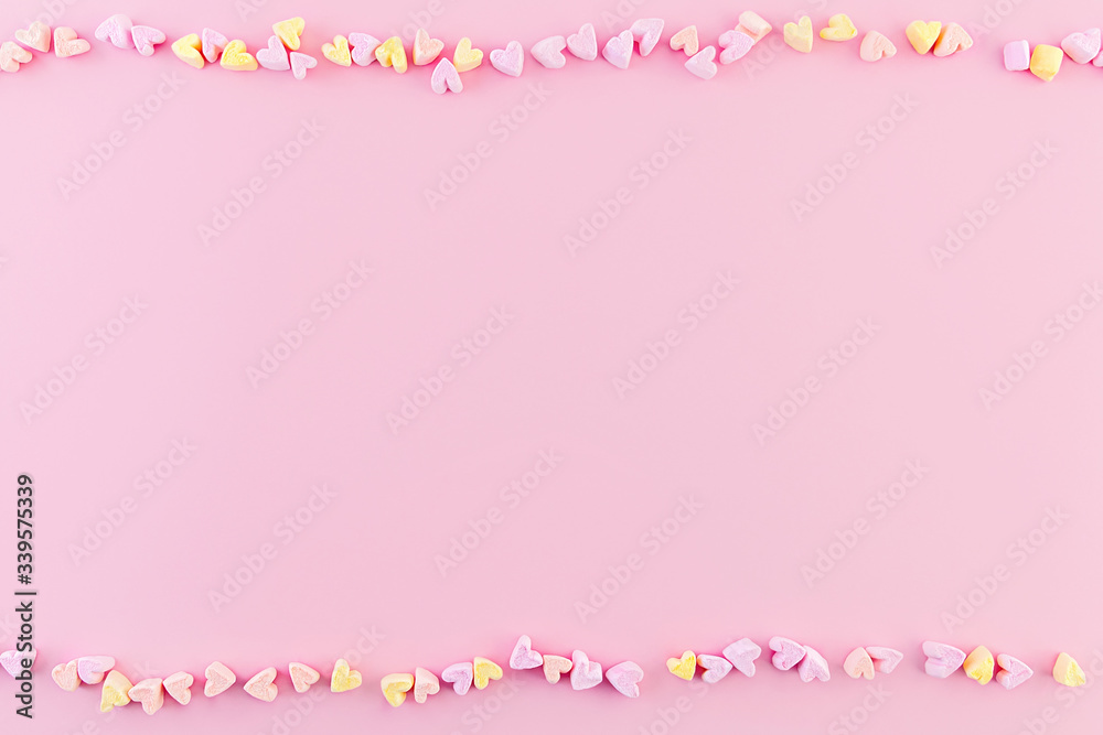 Soft peach background with small marshmallows hearts, place for text.