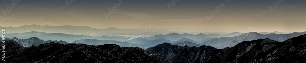 Magic landscape of mountains with fog and clouds in central system, Spain, Europe