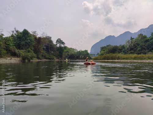 Tourist swimming in the green river in the mountains