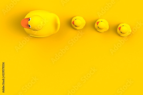 Close up of mum and baby rubber ducks isolated. Bath toys on a yellow background. Top view with copy space. Summer wallpaper. 3d rendering.