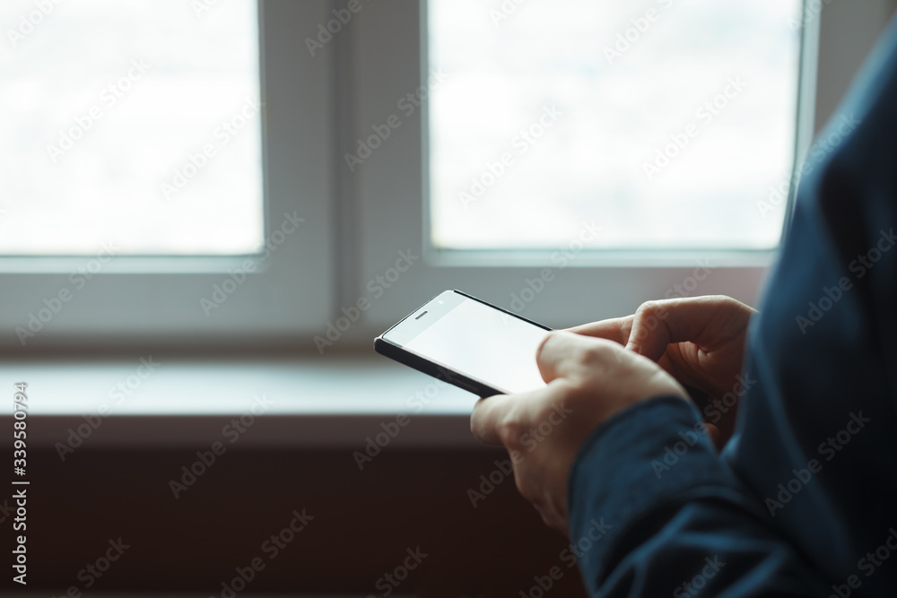 White man texting message on cell phone close up with selective focus