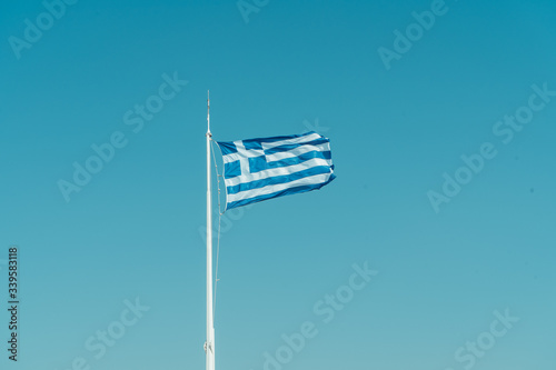 Flag of Greece on the clear blue sky background. Athens, August 2019 photo