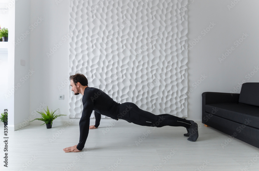 Instructions for calisthenics. Home fitness. COVID-19 concept. Exercises for all muscle groups. Muscular man demonstrates gymnastic exercises. Full push ups - the beginning of the movement. Instructions for calisthenics. Home fitness. COVID-19 concept. Exercises for all muscle groups. Muscular man demonstrates gymnastic exercises. Full push ups - the beginning of the movement.