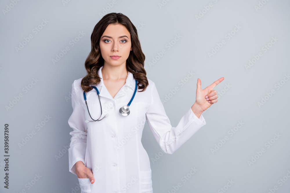 Portrait of her she nice attractive content skilled cheerful wavy-haired girl doc demonstrating copy space ncov sars advice infection isolated over grey pastel color background Portrait of her she nice attractive content skilled cheerful wavy-haired girl doc demonstrating copy space ncov sars advice infection isolated over grey pastel color background