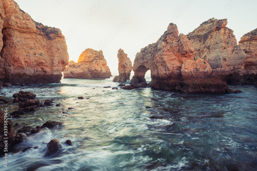 beautiful Atlantic ocean view horizon with sandy beach, rocks and waves at sunrise. Algarve, Portugal beautiful Atlantic ocean view horizon with sandy beach, rocks and waves at sunrise. Algarve, Portugal