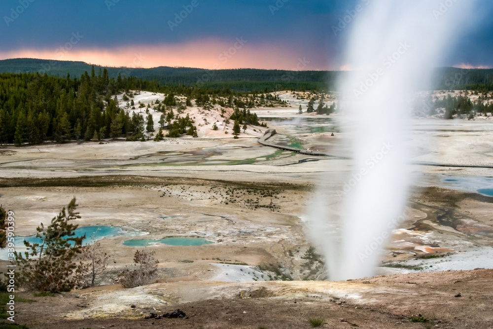 Steaming hot springs during sunset over Yellowstone National Park's Norris Geyser Basin Steaming hot springs during sunset over Yellowstone National Park's Norris Geyser Basin