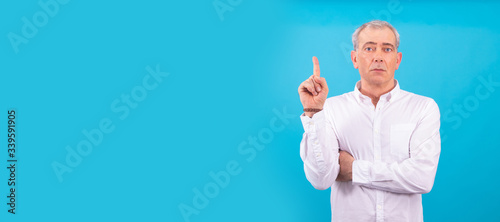 adult or senior man isolated on color background with finger and arm raised