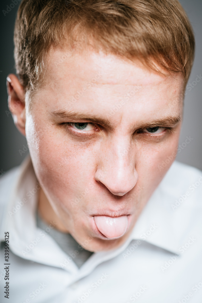 young man shows tongue young man shows tongue