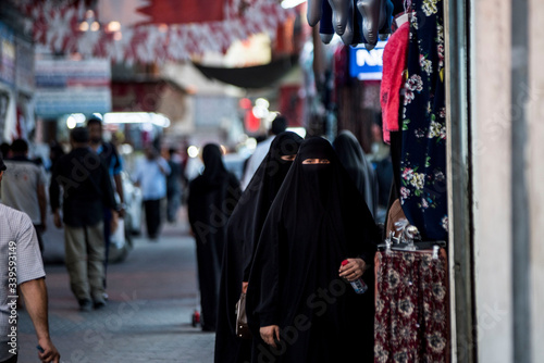 Canvastavla women in burkahs shopping in arab street market