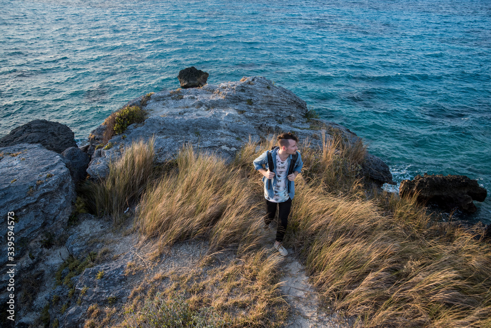 Fototapeta premium male backpacker hiking along the coast in bermuda