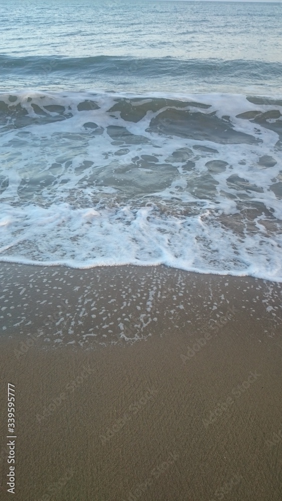 Wave of the sea on the sand beach