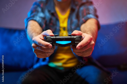 Gamer holding Gamepad, Controller or Videogame Joystick Console in hands. Close up, game concept