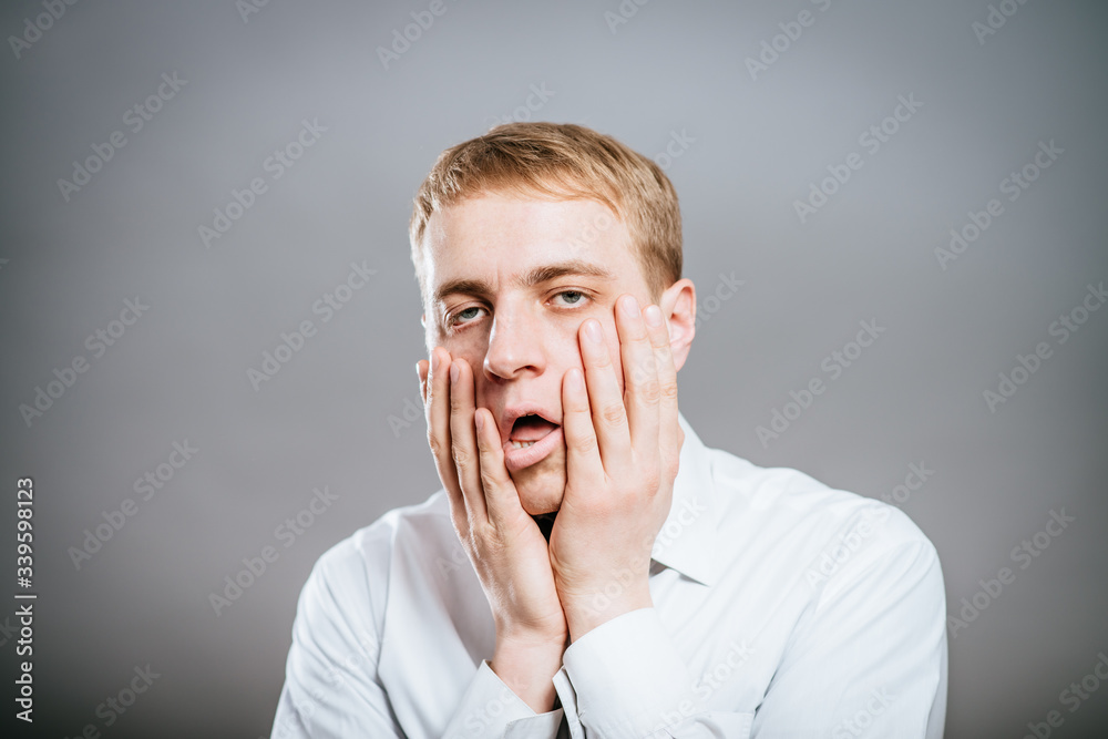 young man with tired, indifferent expression young man with tired, indifferent expression