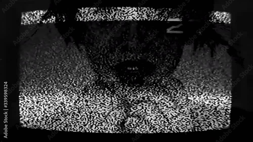Distorted video. Media influence. Woman on analog TV channel bad signal with real static noise.