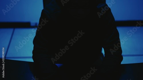A computer programmer or hacker prints a code on a laptop keyboard to break into a secret organization system.