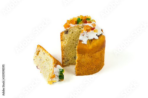 Easter cake with candied fruit with a cut piece on a white background