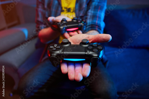 Gamer holding Gamepad, Controller or Videogame Joystick Console in hands. Close up, game concept