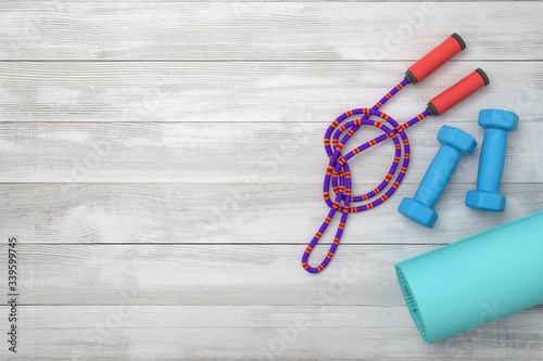 3d rendering of violet jumping rope, blue dumbbells and fitness mat on wooden background