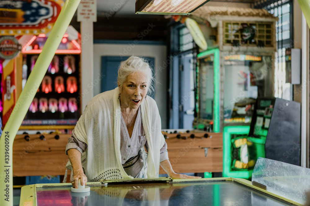 Happy woman playing a game of table hockey