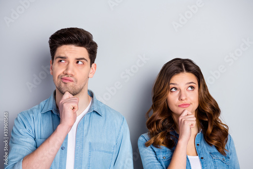 Photo two people lady handsome guy couple look up empty space doubtful situation who is right wrong wear casual denim shirts outfit clothes isolated grey color background