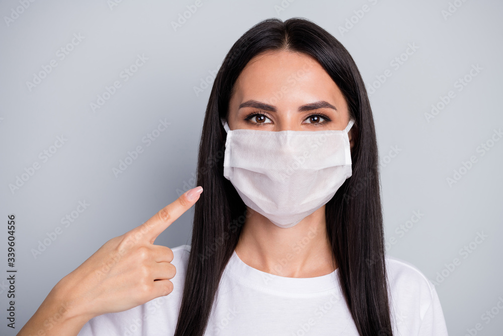 Portrait of confident girl promoter point medical mask indicate new safety covid-29 protection wear casual style outfit isolated over gray color background Portrait of confident girl promoter point medical mask indicate new safety covid-29 protection wear casual style outfit isolated over gray color background