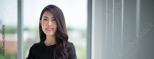 Headshot young lady standing in office