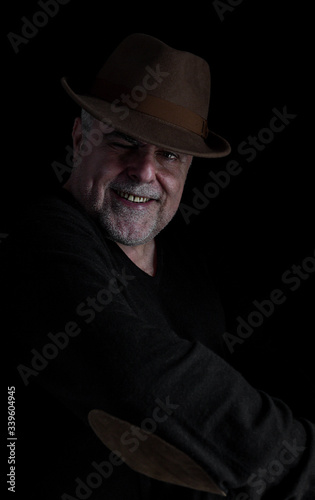 Portrait of mature man with beard on dark background