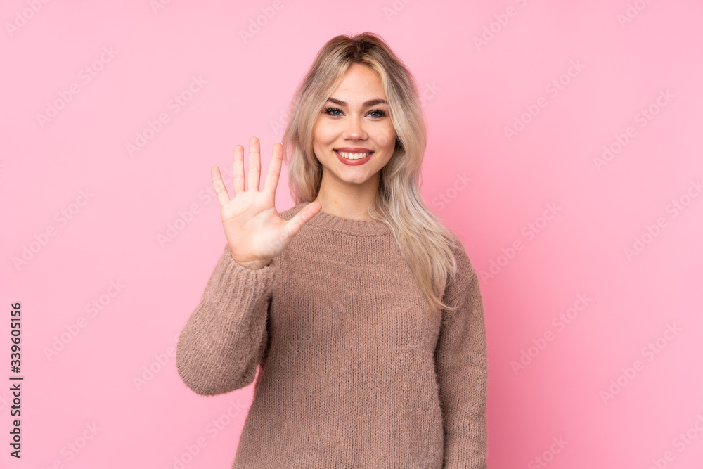 Teenager blonde girl wearing a sweater over isolated pink background counting five with fingers Teenager blonde girl wearing a sweater over isolated pink background counting five with fingers