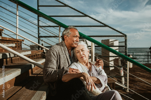 Senior couple sitting together by the sea