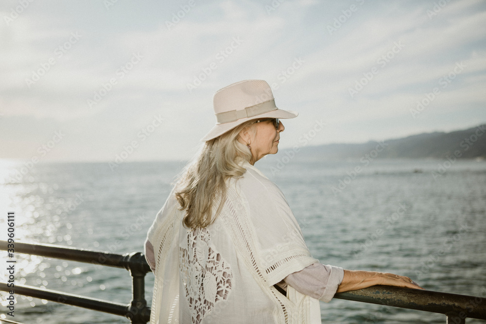 Senior woman on the pier by the sea
