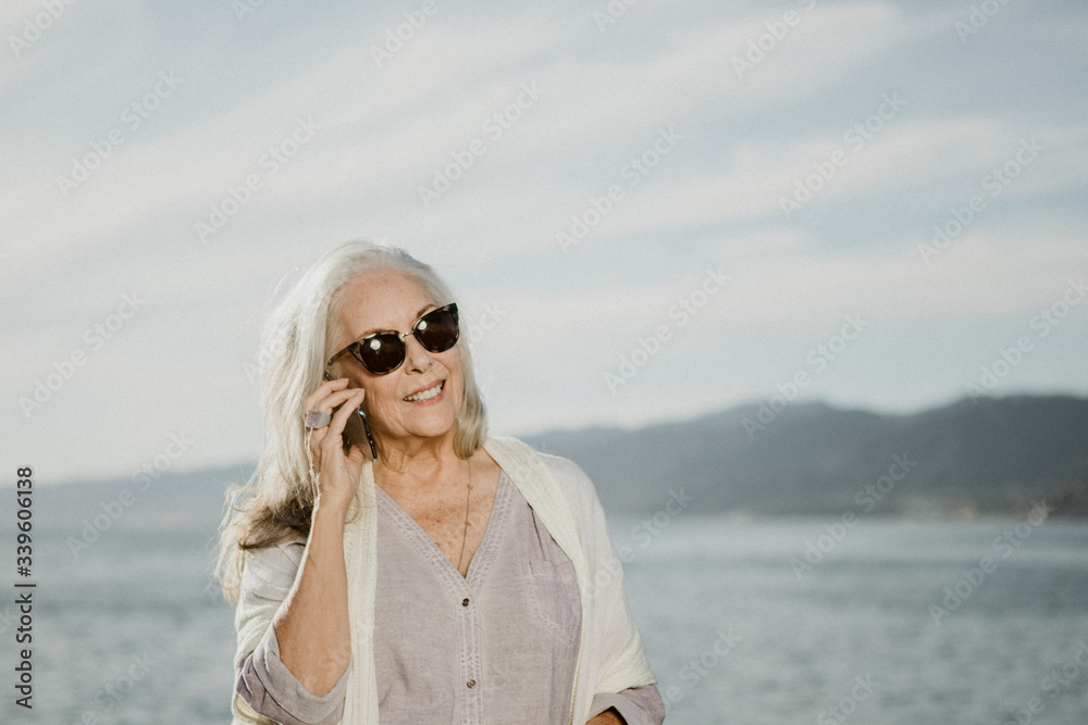 Woman on a call by the ocean Woman on a call by the ocean