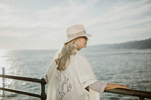 Senior woman on the pier by the sea © rawpixel.com
