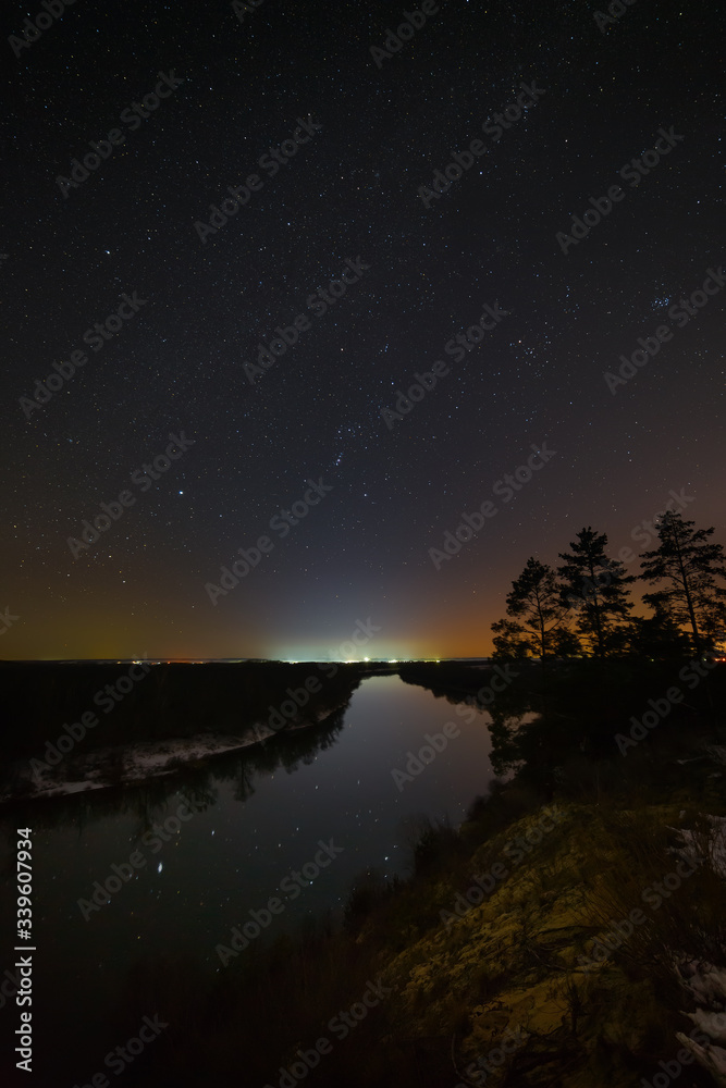 Bright stars of the night sky over the river. Landscape with a view of outer space. Bright stars of the night sky over the river. Landscape with a view of outer space.