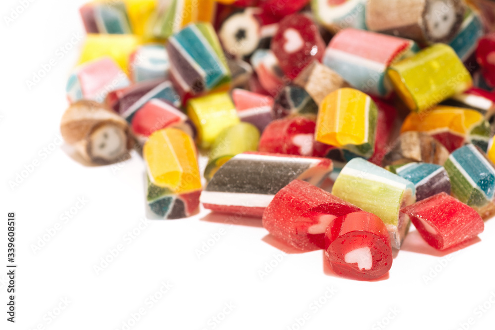 mix of multi-colored bright sweet lollipops isolated on a white background. close up. macro mix of multi-colored bright sweet lollipops isolated on a white background. close up. macro