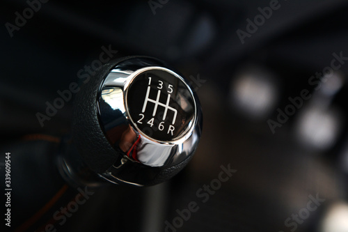 Manual six-speed gearshift for a car, Closeup photo of car interiors in dark light photo