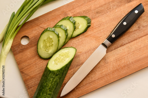 cucumber and knife on cutting board