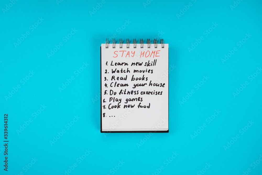 Self isolation, quarantine check list written on the notepad. Blue ...