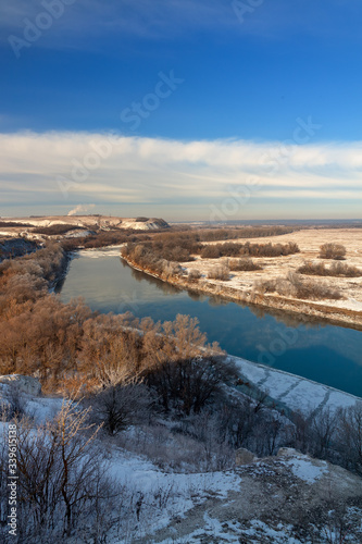 The first snow on the river, grass and trees. Autumn landscape in central Russia.