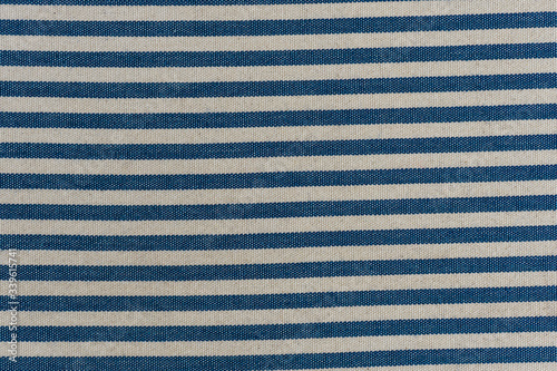 Nautical textile texture for background. Close up of a marine textile texture with blue and white stripes.