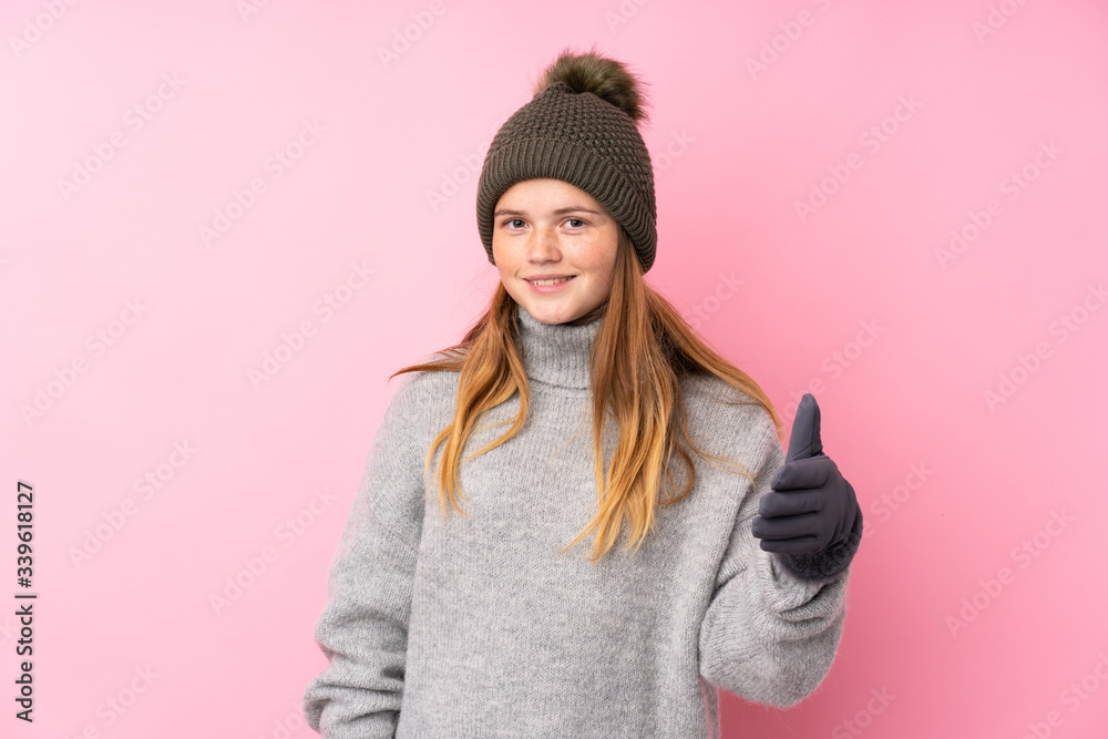 Ukrainian teenager girl with winter hat over isolated pink background handshaking after good deal Ukrainian teenager girl with winter hat over isolated pink background handshaking after good deal