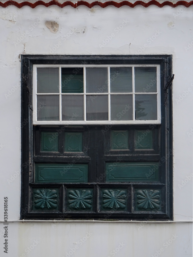 Traditional guillotine wood window in historic colonial house. Old city center of Santa Cruz. La Palma Island. Canary Islands. Spain. 